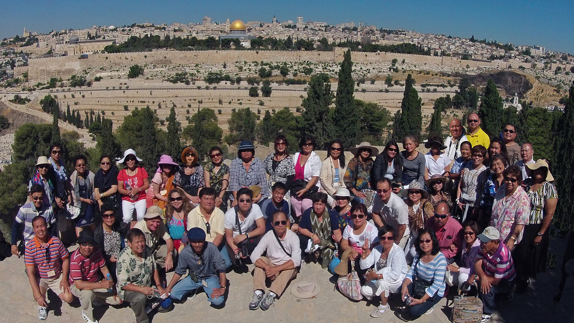 Happy client standing on the Mount of Olives overlooking Jerusalem during a Lionsgate Travel Holy Land tour.