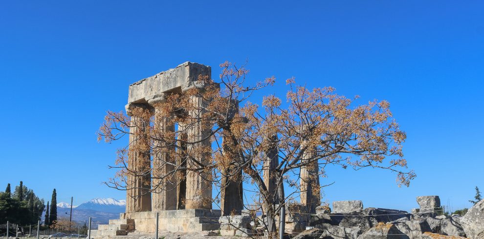 Scenic view of Corinth, Greece, showcasing the historic ruins and vibrant modern life, blending ancient heritage with contemporary culture.